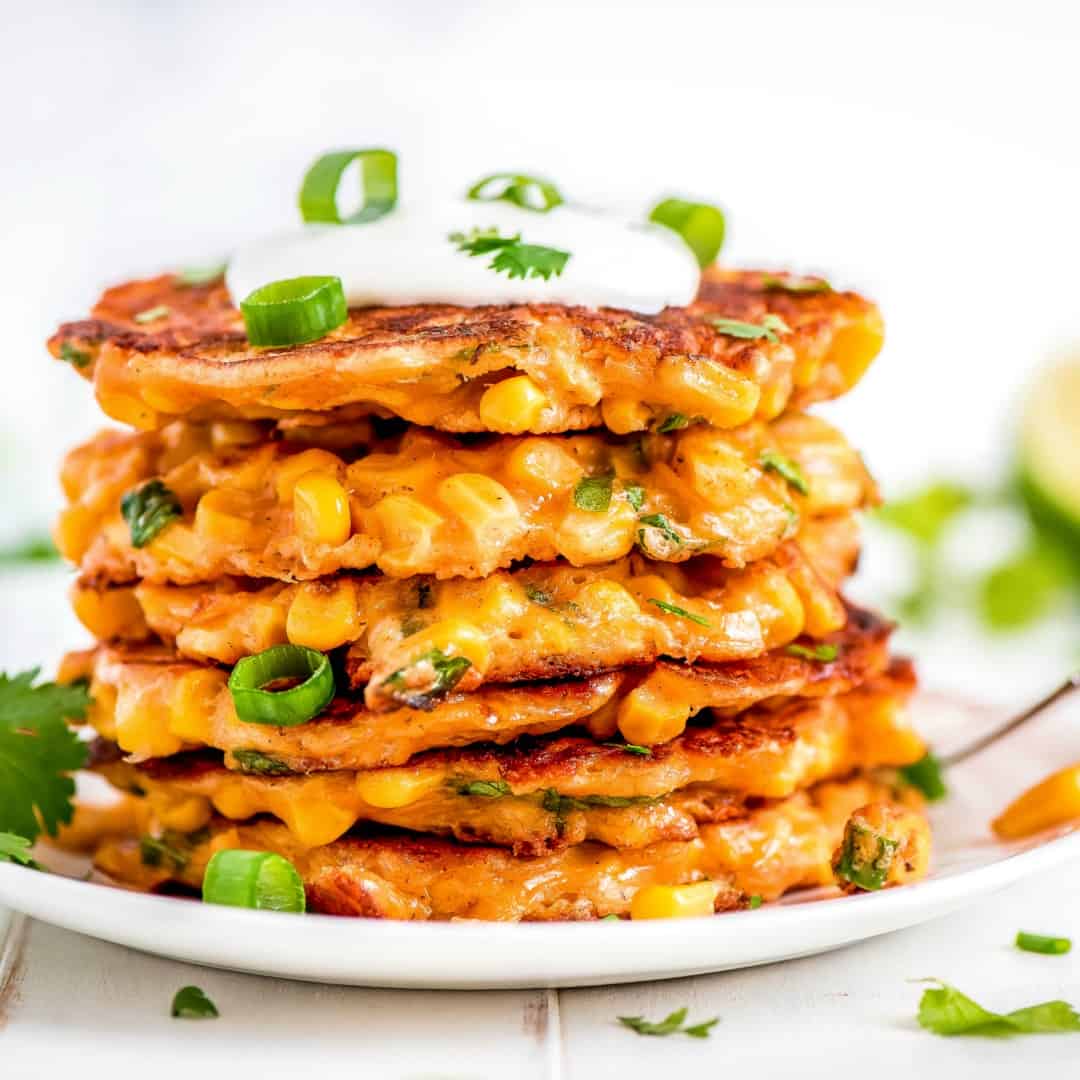 Corn Fritters are the perfect way to enjoy corn! You won't be able to resist the crispy little cakes loaded with sweet golden corn and lots of cheese!