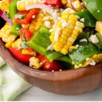 corn salad in a wooden serving bowl with recipe name at the bottom