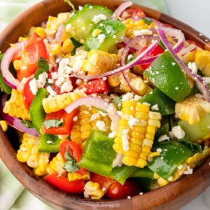 square image of corn salad in a wooden serving bowl