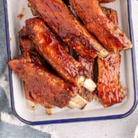 country style pork ribs piled on a platter with recipe name at the bottom