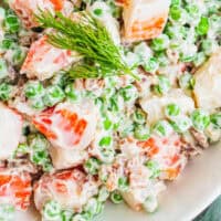 close up of crab, pea & bacon salad in a bowl with recipe name at the bottom