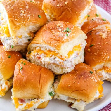 square image of crack chicken sliders stacked on a plate