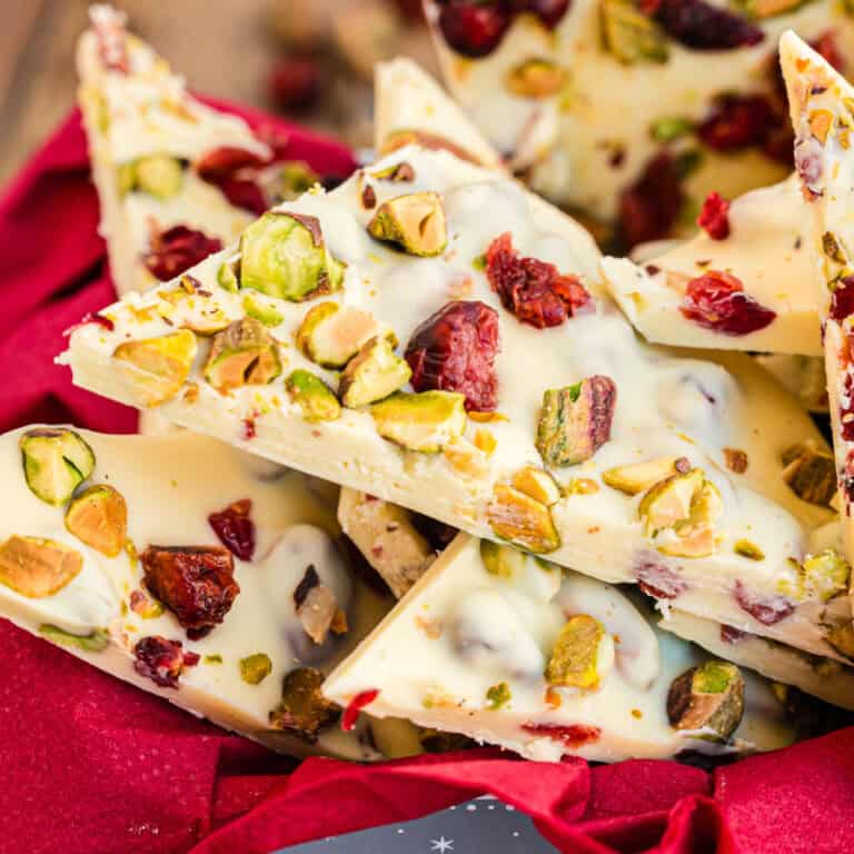 square image of cranberry pistachio bark in a lined tin