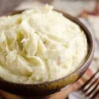 Cream Cheese Garlic Mashed Potatoes are a rich and hearty family favorite! This side dish is a delicious 3 ingredient recipe perfect for a holiday meal or a Sunday dinner!