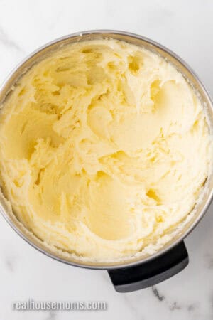 butter, sugar, and cream cheese beaten together in a metal mixing bowl