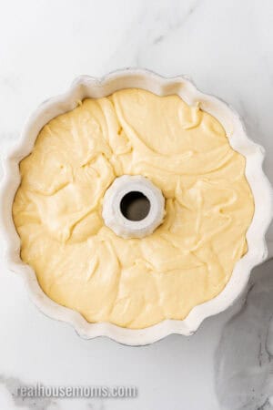 cream cheese pound cake spread out in a bundt cake pan