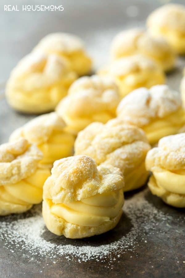 Filled cream puffs sprinkled with powdered sugar