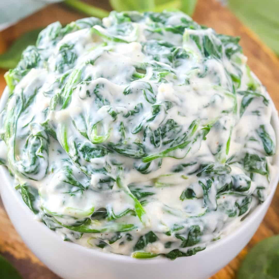 Creamy, cheesy and full of flavor - this Creamed Spinach makes the perfect side dish to any weeknight meal and is ready in about 15 minutes!