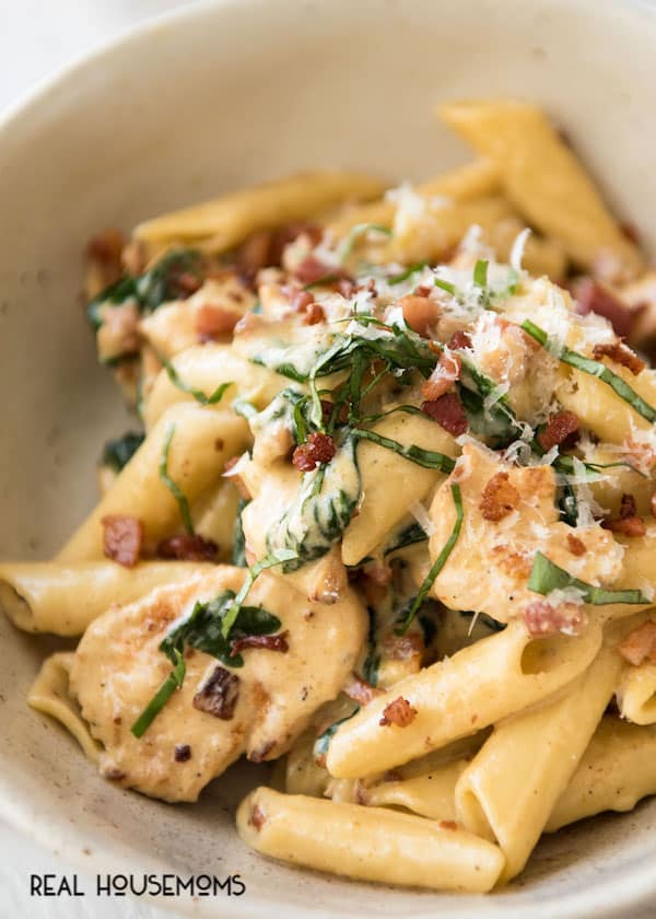 Creamy Chicken Bacon Ziti served up in a bowl topped with basil and parmesan