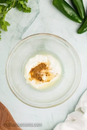 sour cream, lemon juice, lime, juice, and seasonings in a small glass bowl