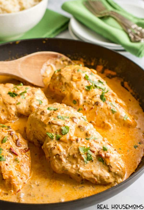 Serving spoon lifting Creamy Chipotle Chicken out of a skillet