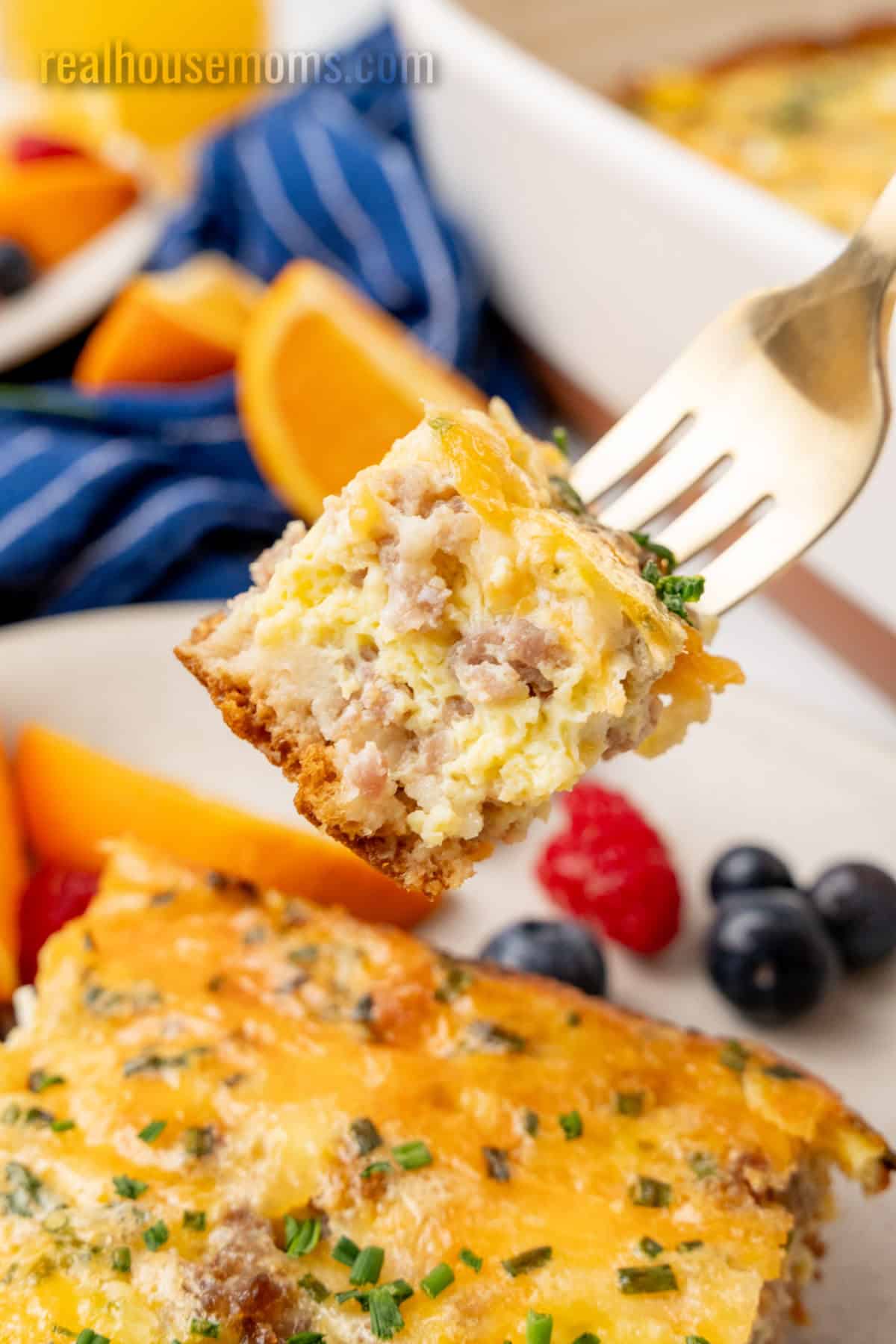 bite of crescent roll breakfast casserole on a fork over the plate