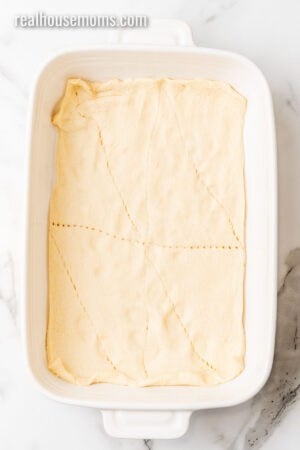 crescent roll dough pressed into the bottom of a 9x13 baking dish