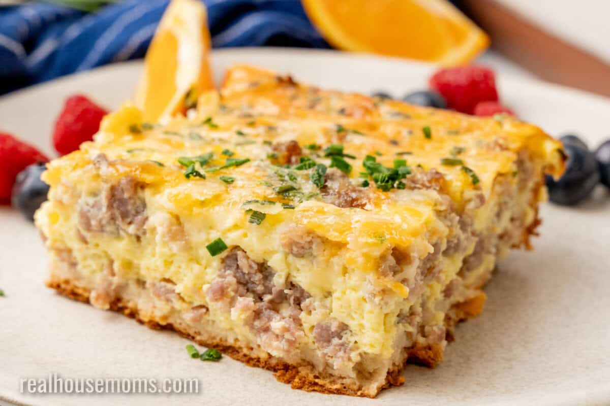 slice of crescent roll breakfast casserole on a plate with fresh fruit