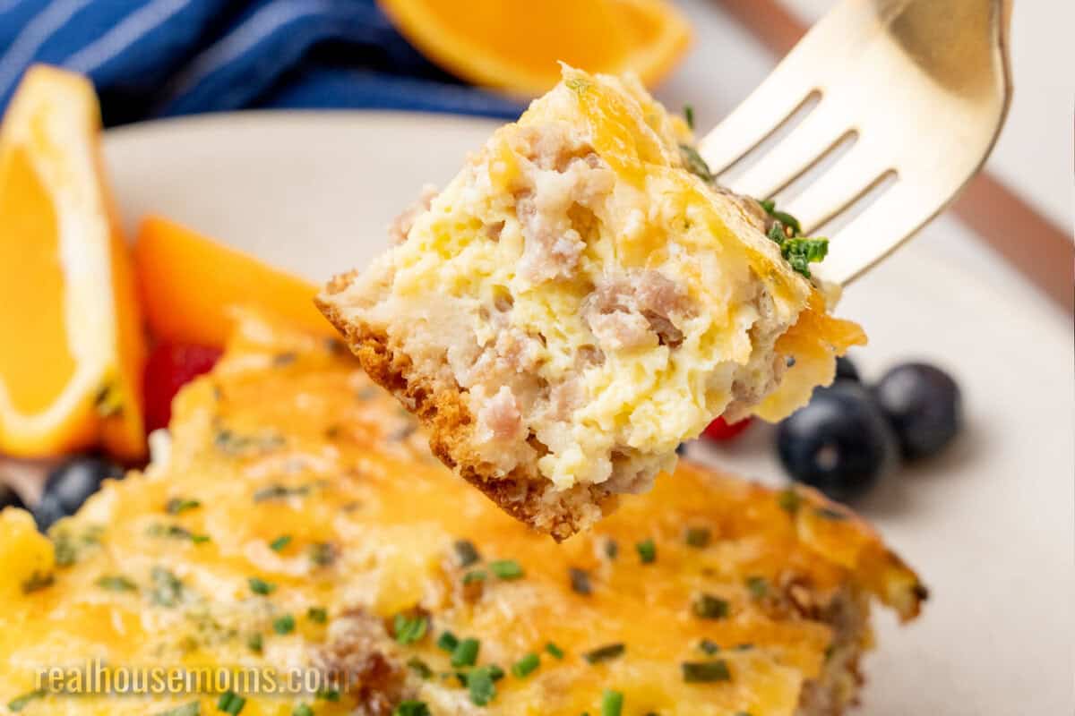 bite of crescent roll breakfast casserole on a fork over the plate