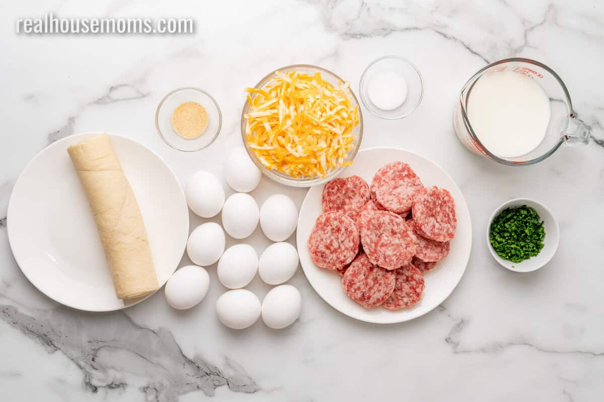 ingredients to make crescent roll breakfast casserole laid out on a marble counter