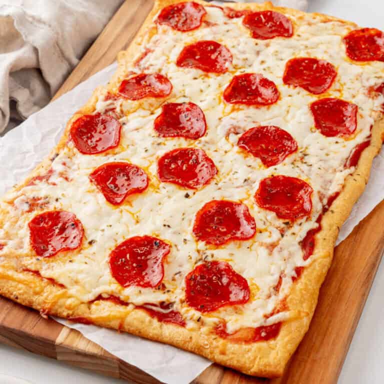 square image of a crescent roll pizza on a cutting board