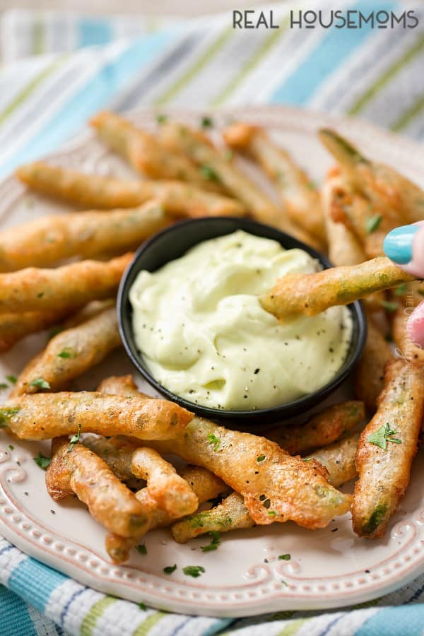 Crispy Fried Green Bean being dipped into Wasabi Mayo