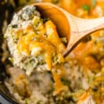square image of Crock Pot Cheesy Broccoli Chicken and Rice portion on a spoon