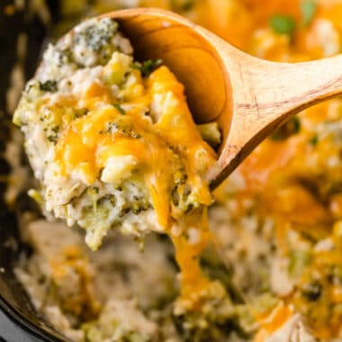 square image of Crock Pot Cheesy Broccoli Chicken and Rice portion on a spoon