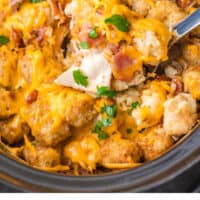 spoonful of crock pot cheesy chicken, bacon & tater tot bake over the slow cooker with recipe name at the bottom