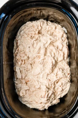 shredded chicken mixed into ranch cream cheese sauce in a slow cooker