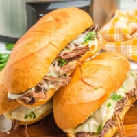 square image of 3 crock pot french dip sandwiches stacked up