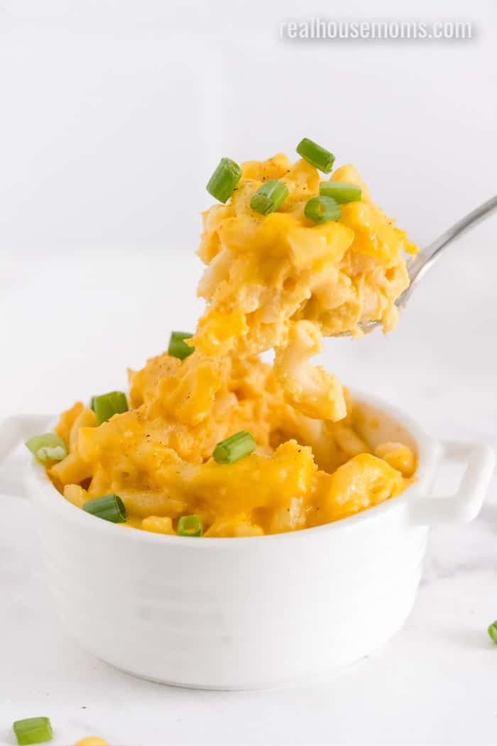 spoonful of mac and cheese being lifted from a bowl