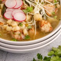 crock pot pozole in a bowl with recipe name at the bottom