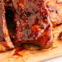 crock pot ribs on a cutting board with recipe name at the bottom