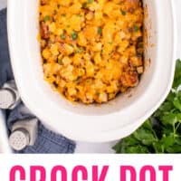 wooden spoon in a slow cooker of crock pot sausage & potato casserole with recipe name at the bottom