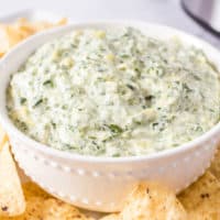bowl of creamy spinach artichoke dip made in a slow cooker