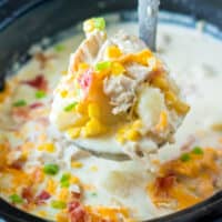 square image of a ladle of crock pot turkey chowder over the crock