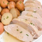 square image of sliced crock pot turkey tenderloin and potatoes
