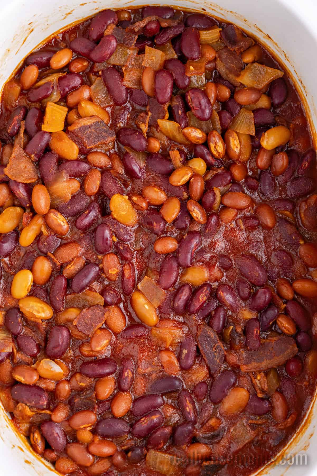 close up of cooked crockpot baked beans in the slow cooker