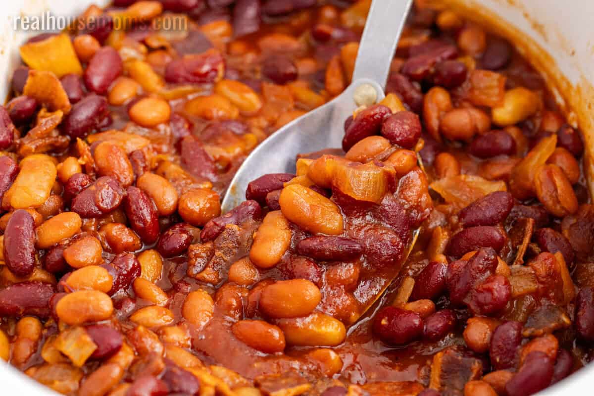 spoonful of crockpot baked beans over the slow cooker