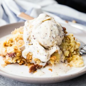 Crock Pot Crunchy Pecan Apple Cobbler is a warm and totally delicious apple cobbler that you make your slow cooker in no time at all! Just toss all the ingredients in and give it a couple hours!