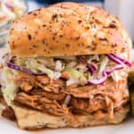 square image of a crockpot honey bbq chicken sandwich with coleslaw