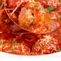 spoonful of crockpot meatballs over the slow cooker with recipe name at the bottom