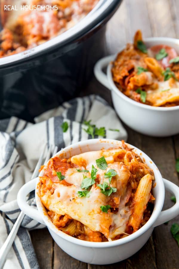 Crock Pot Pizza Casserole served in bowls and topped with chopped fresh parsley