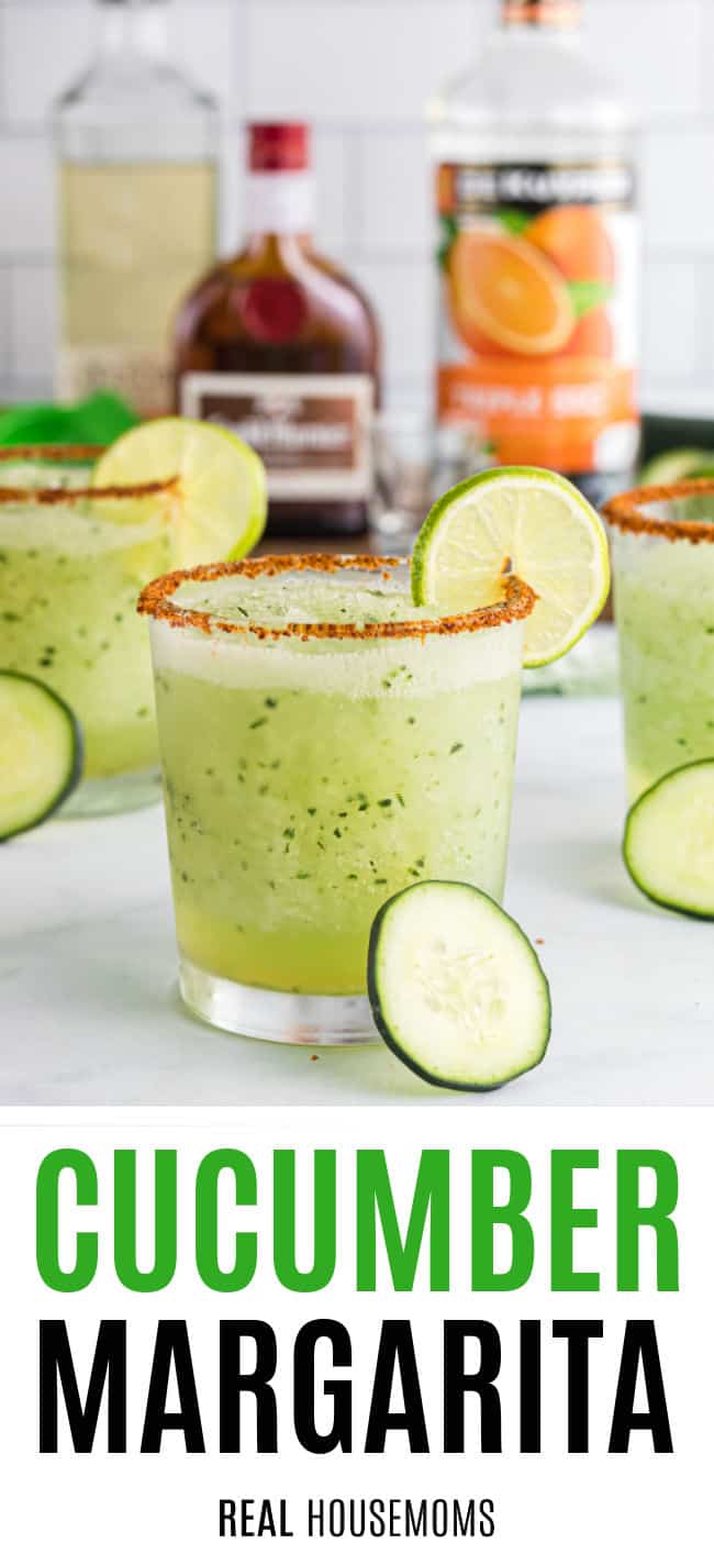 spiced slat rimmed rocks glasses with frozen cucmber margaritas garnished with a lime slice and slices on cucumber on the counter around the glasses
