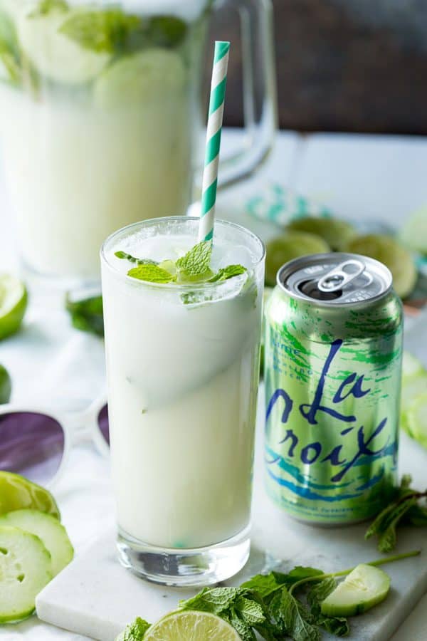 Cucumber Mint Mojito served in a collins glass with a straw alongside a La Croix soda water can.