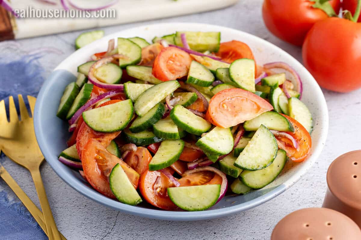 angled view of cucumber tomato salad in a serving bowl