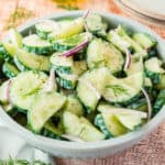 square image of cucumber yogurt dill salad in a serving bowl