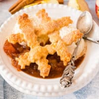 square image of deconstructed apple pie a la mode in a bowl with a spoon