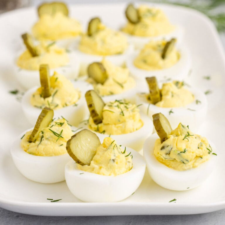 square image of dill pickle deviled eggs on a serving platter
