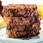 square image of double chocolate banana bread slices stacked up on a plate