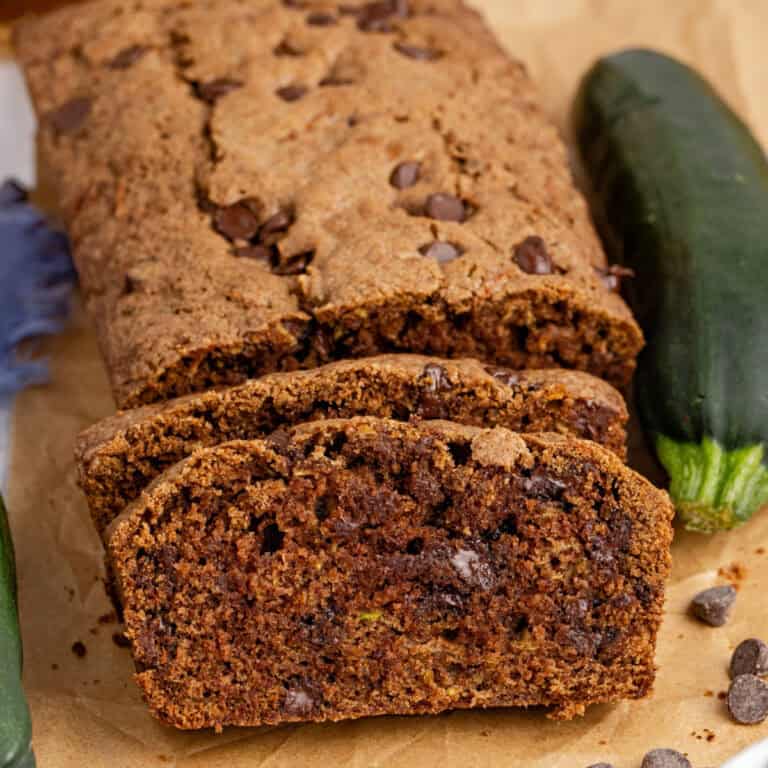 square image of slices of double chocolate zucchini bread leaning on the loaf