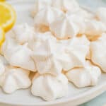 square image of double lemon meringue cookies piled on a plate