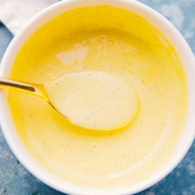 square image of blender hollandaise sauce in a bowl with a spoon